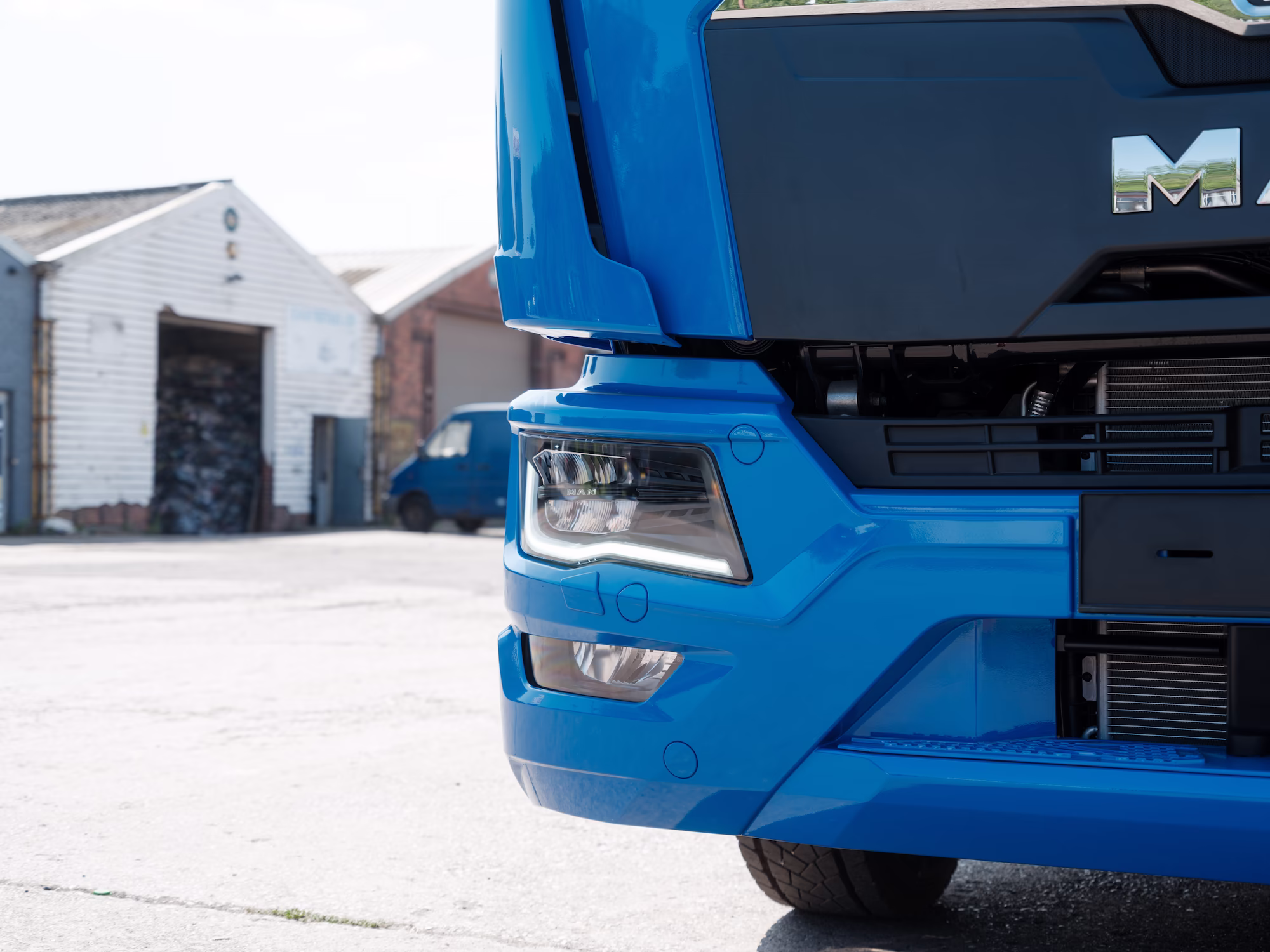 The front corner of a blue MAN Truck, built and painted by WCC.