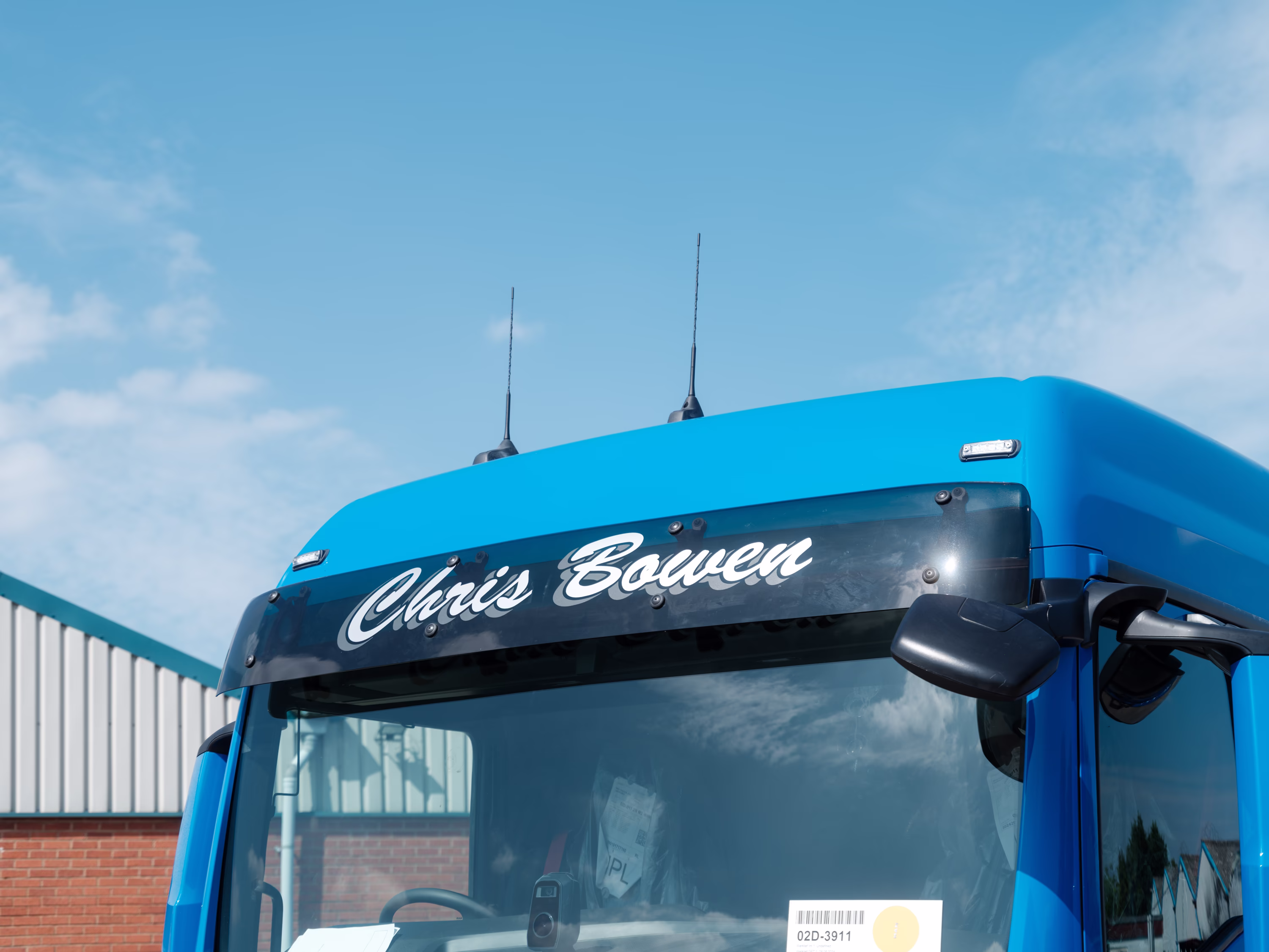 The visor of an MAN truck that says 'Chris Bowen'.