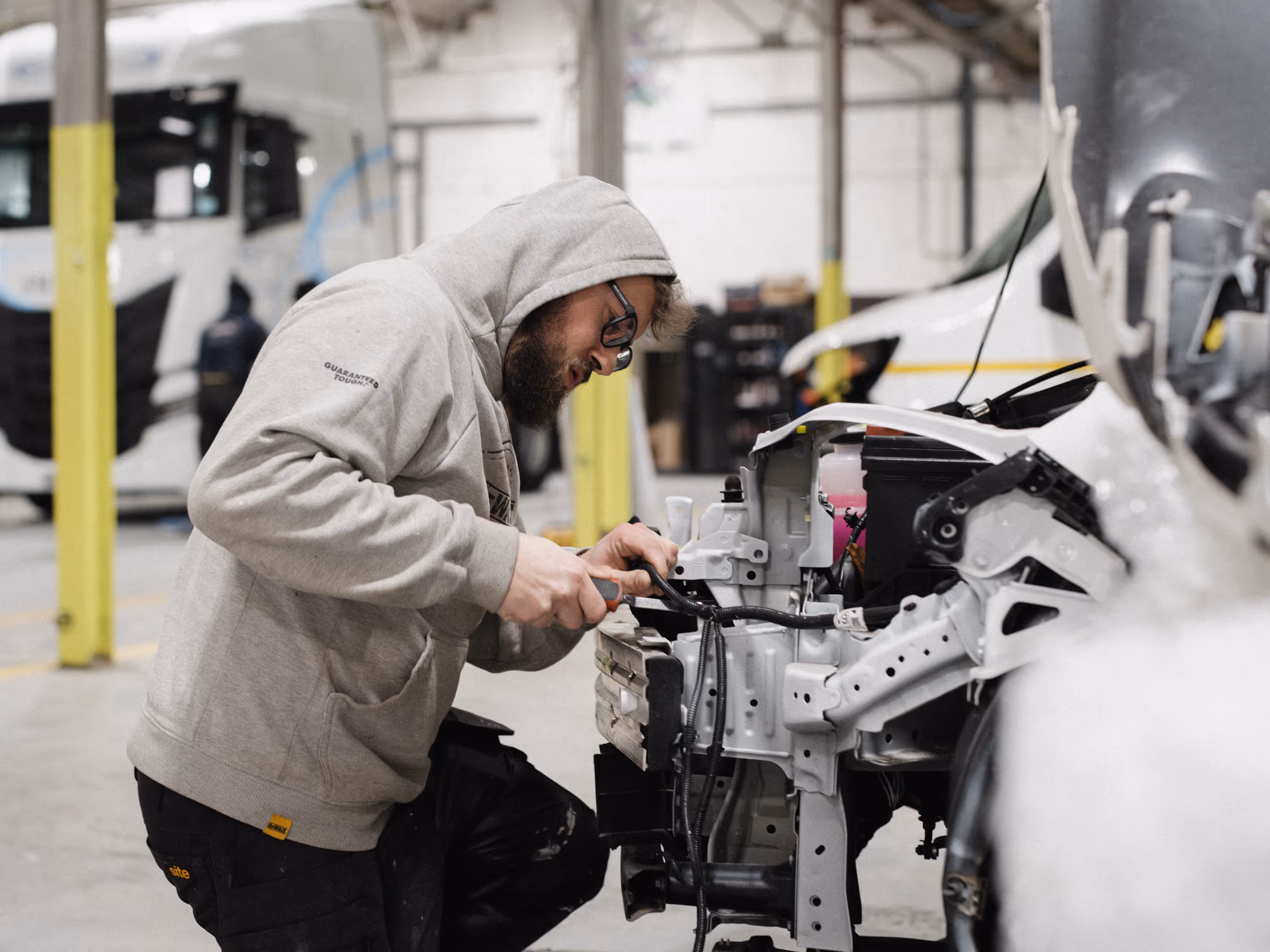 a wcc worker taken apart the front end of a fleet car.