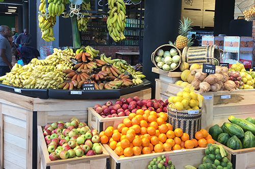 store with colorfull fruits placed in crates