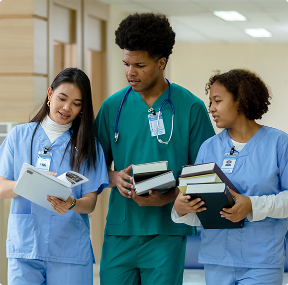 Mature female doctor discussing medical report with nurses in hospital hallway