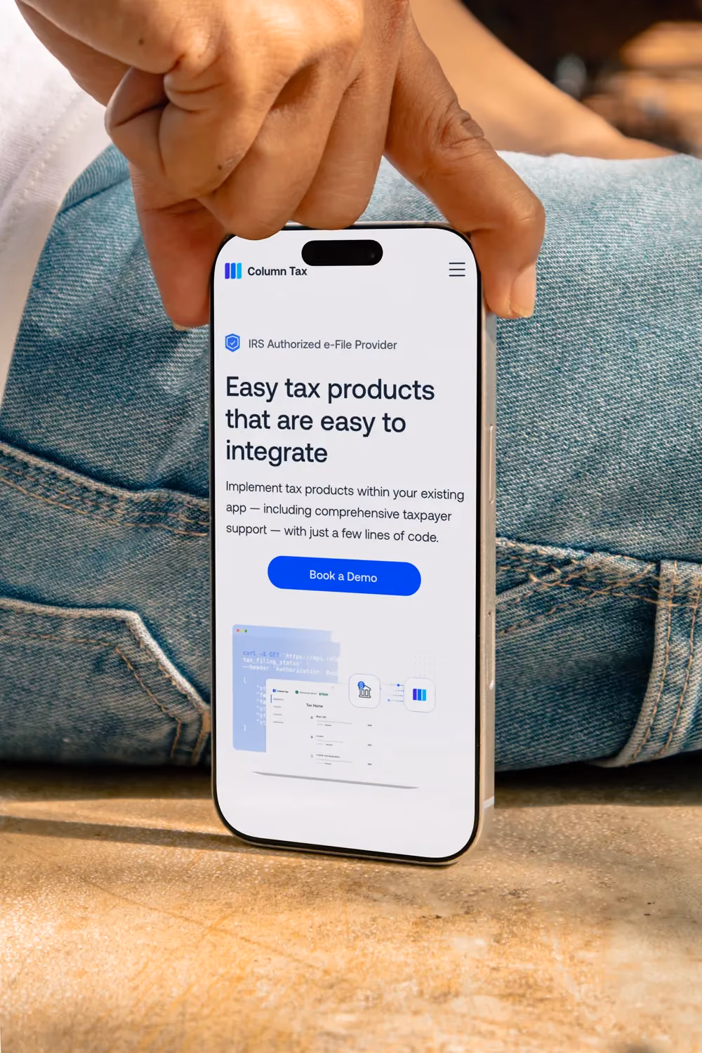 Column Tax mobile website showing embedded tax integration features on iPhone held in pocket