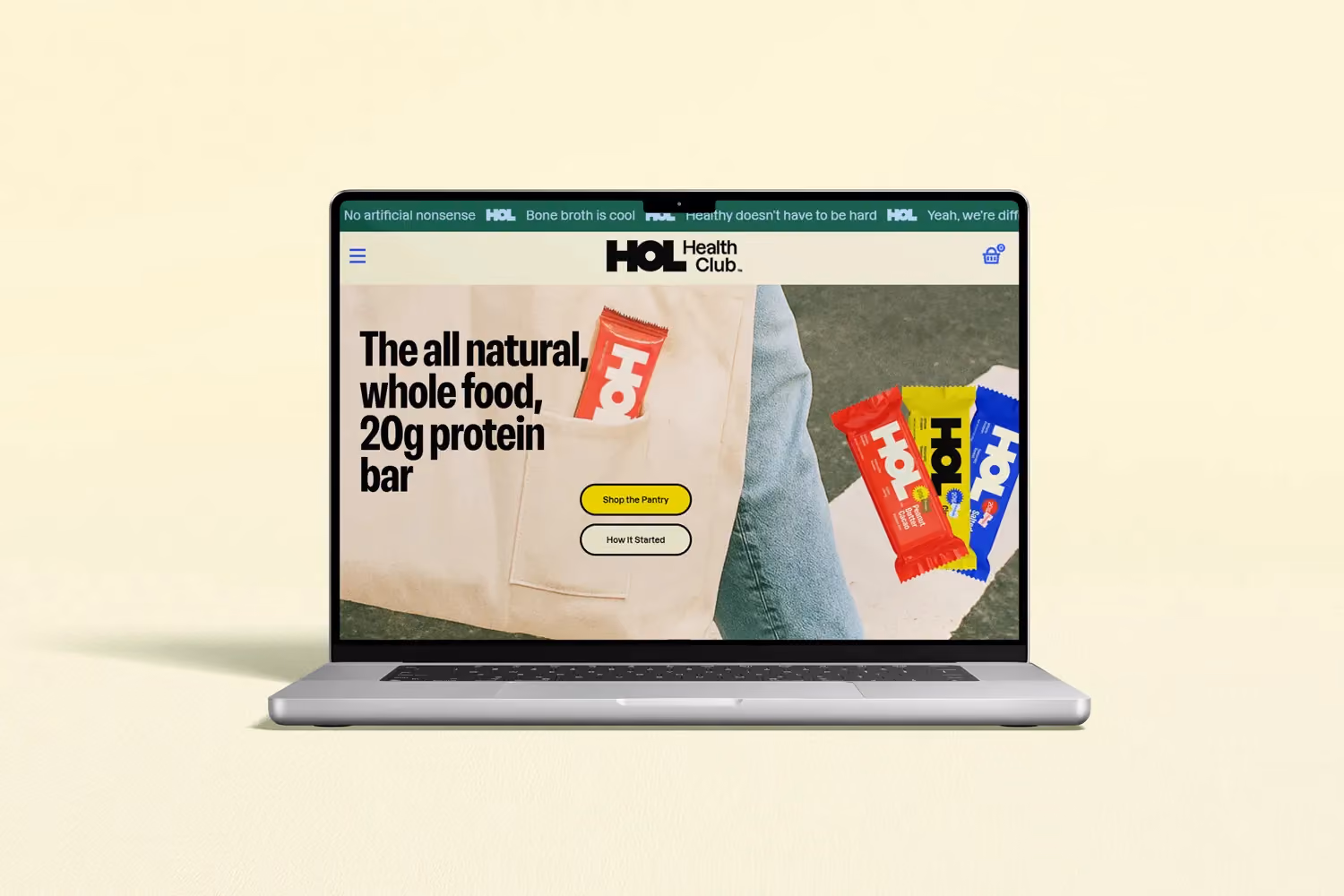 HOL Health Club laptop mockup showing whole-food protein bar product page