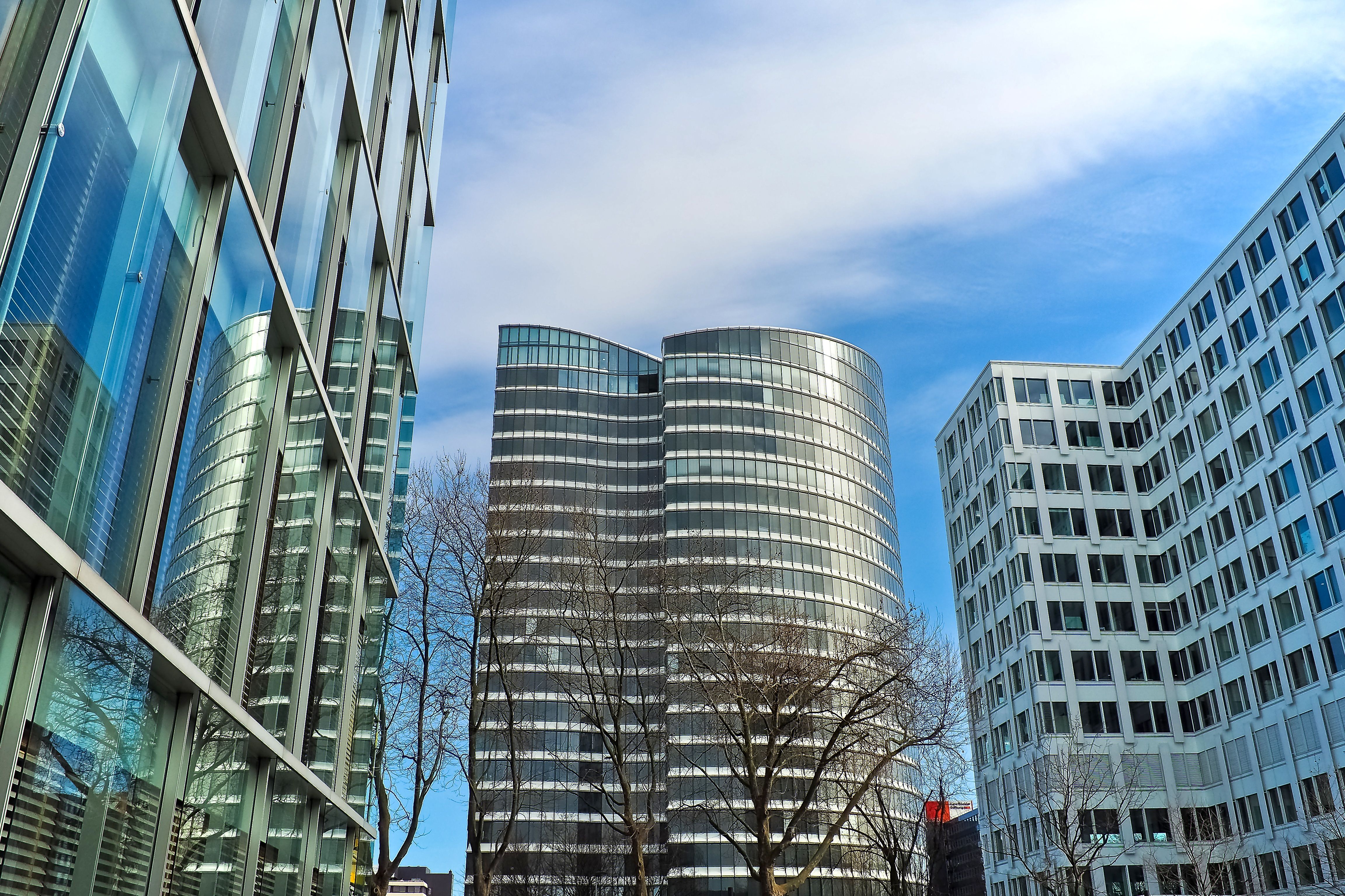 A striking view of modern skyscrapers against a clear blue sky, showcasing contemporary architectural design.