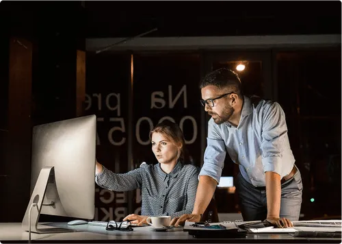 corporate employees looking at computer screen