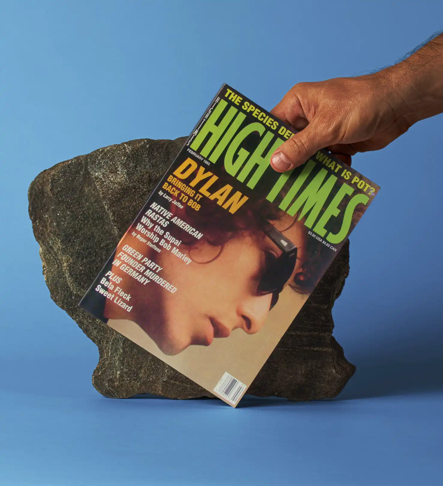 Forleap Marketing. High Times cover image case study. Hand holding a February 1993 High Times magazine featuring Bob Dylan on the cover, propped against a dark rock on a blue background.