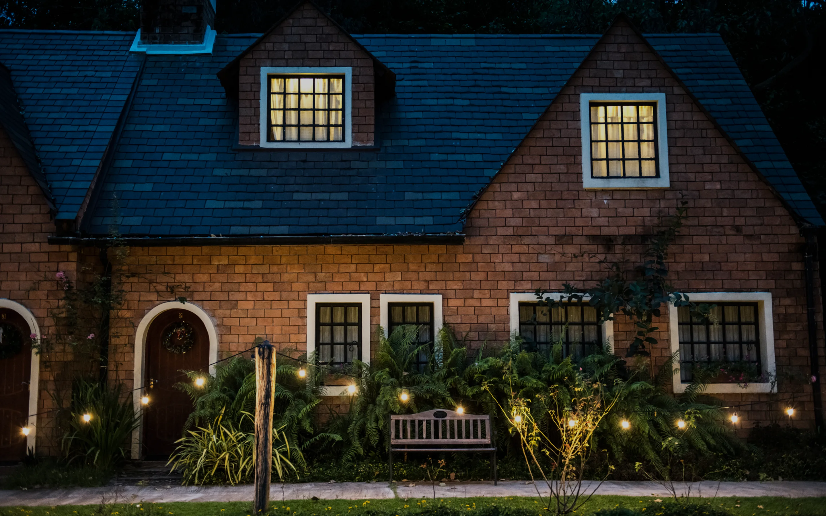 A house with a bench in front of it.