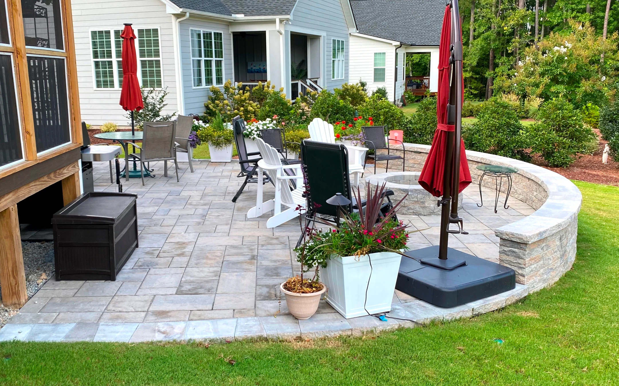 A patio with a table and chairs and a potted plant.