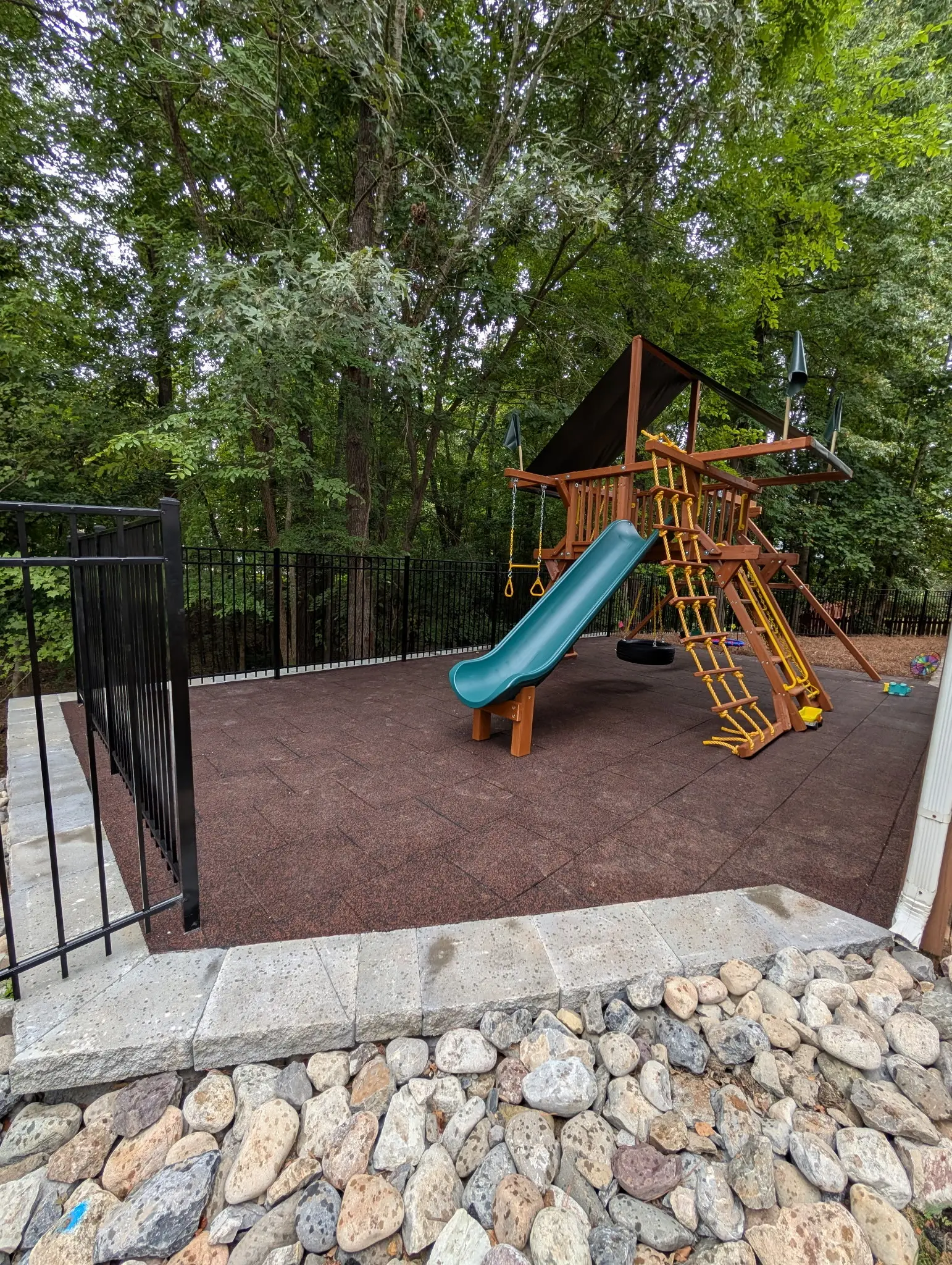 A playground with a slide and a swing.