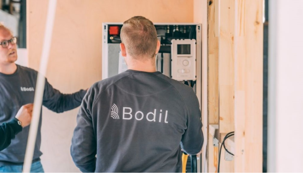 Bodil energi repairmen reducing CO2 emissions by working on solar panel and heat pump