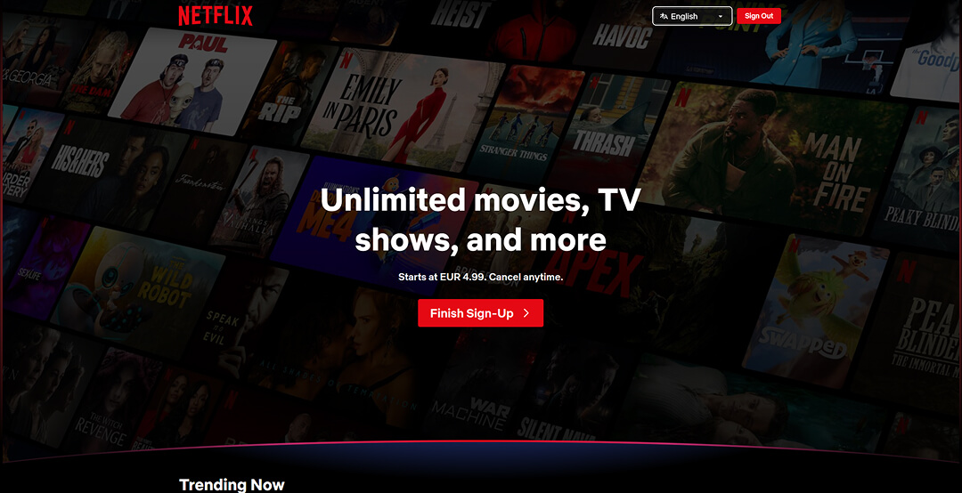Netflix-Landingpage mit einem dunklen Hintergrund-Raster aus Filmplakaten, der Überschrift „Unlimited movies, TV shows, and more“ und einem roten „Finish Sign-Up“-Button