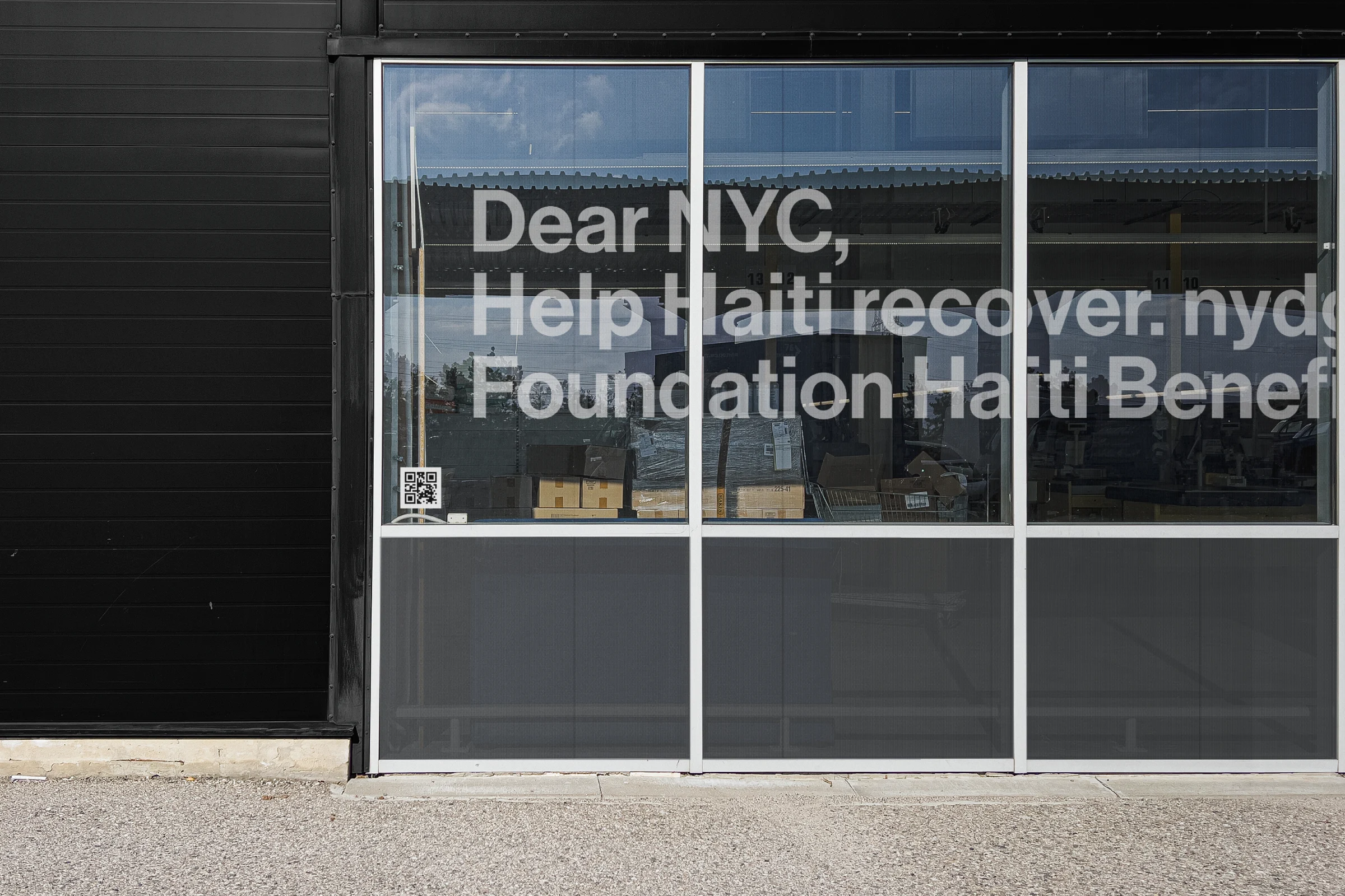 A storefront ad for the Haiti Benefit awareness campaign
