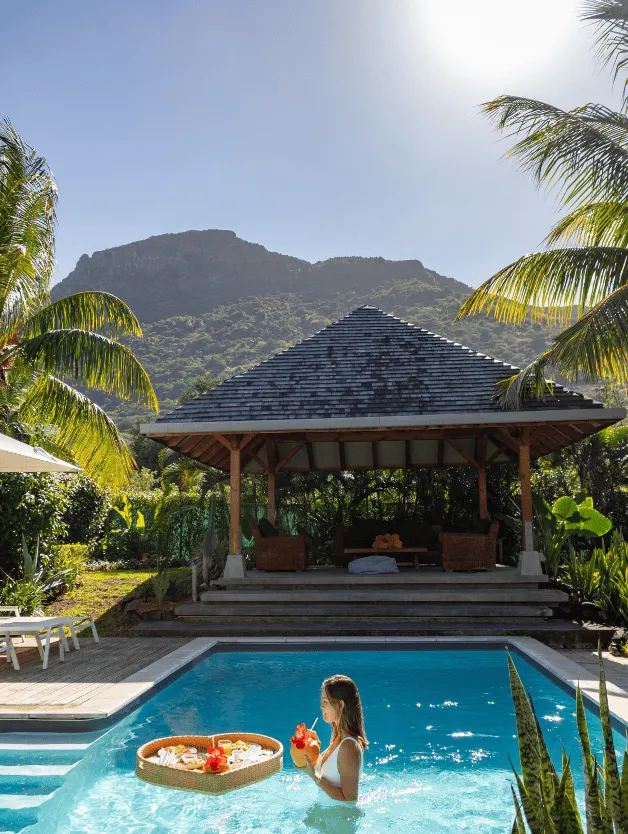 Woman relaxing in a private pool in Mauritius with MJ Holidays.