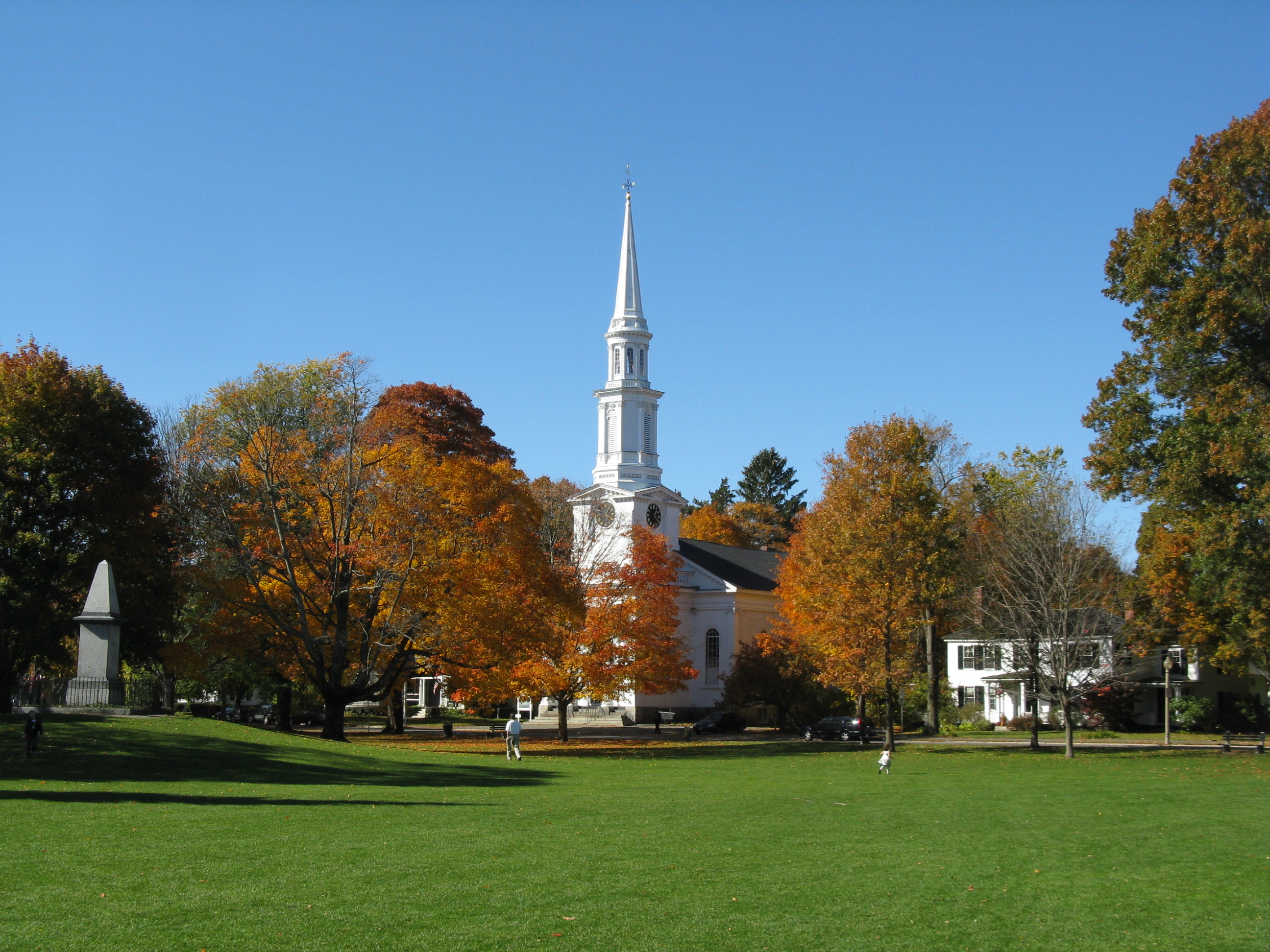 this photo shows lexington battle green in downtown lexington. there is a church in the background