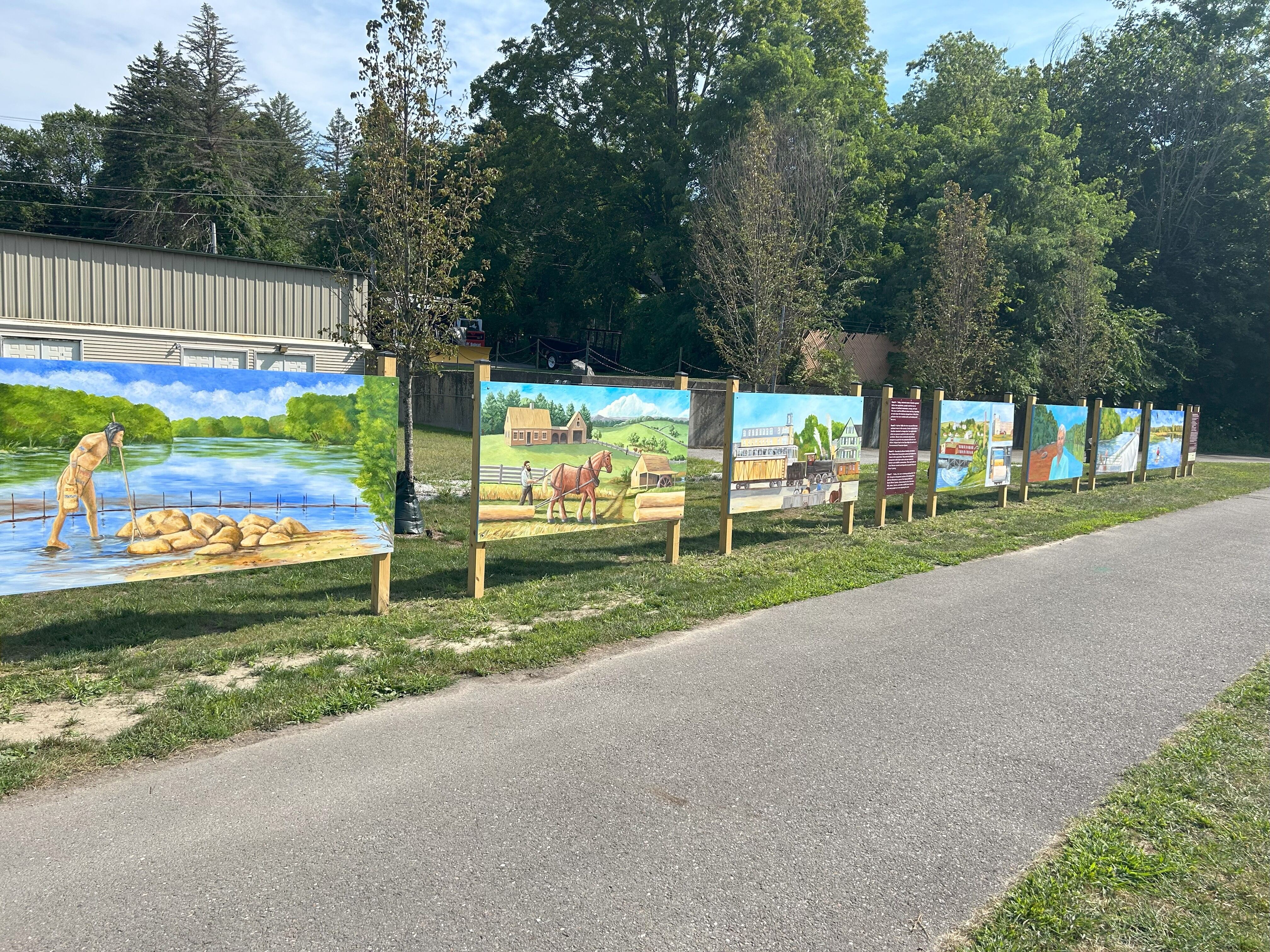 a series of painted panels alongside the trail