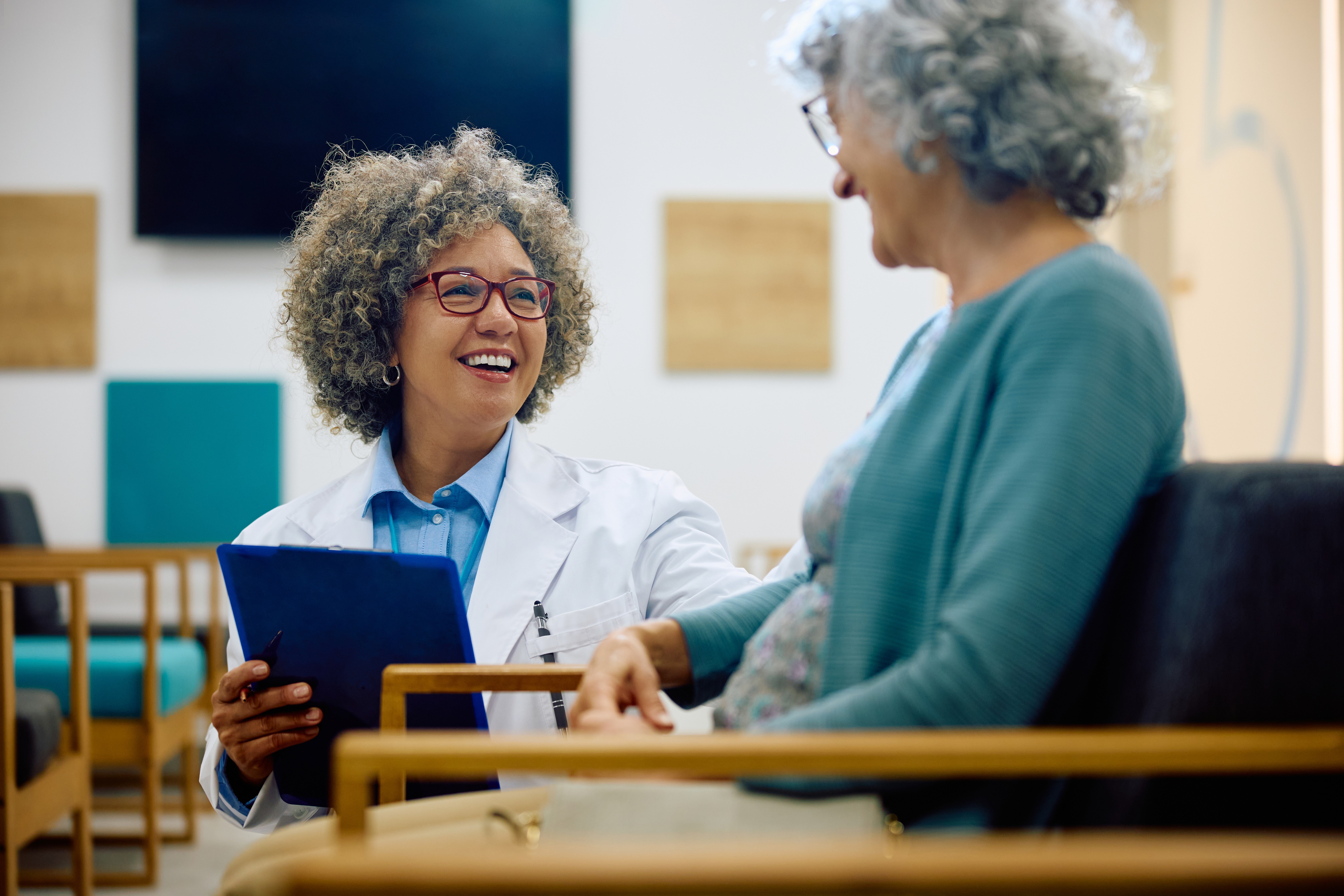 A physician talking with a patient at an infusion center