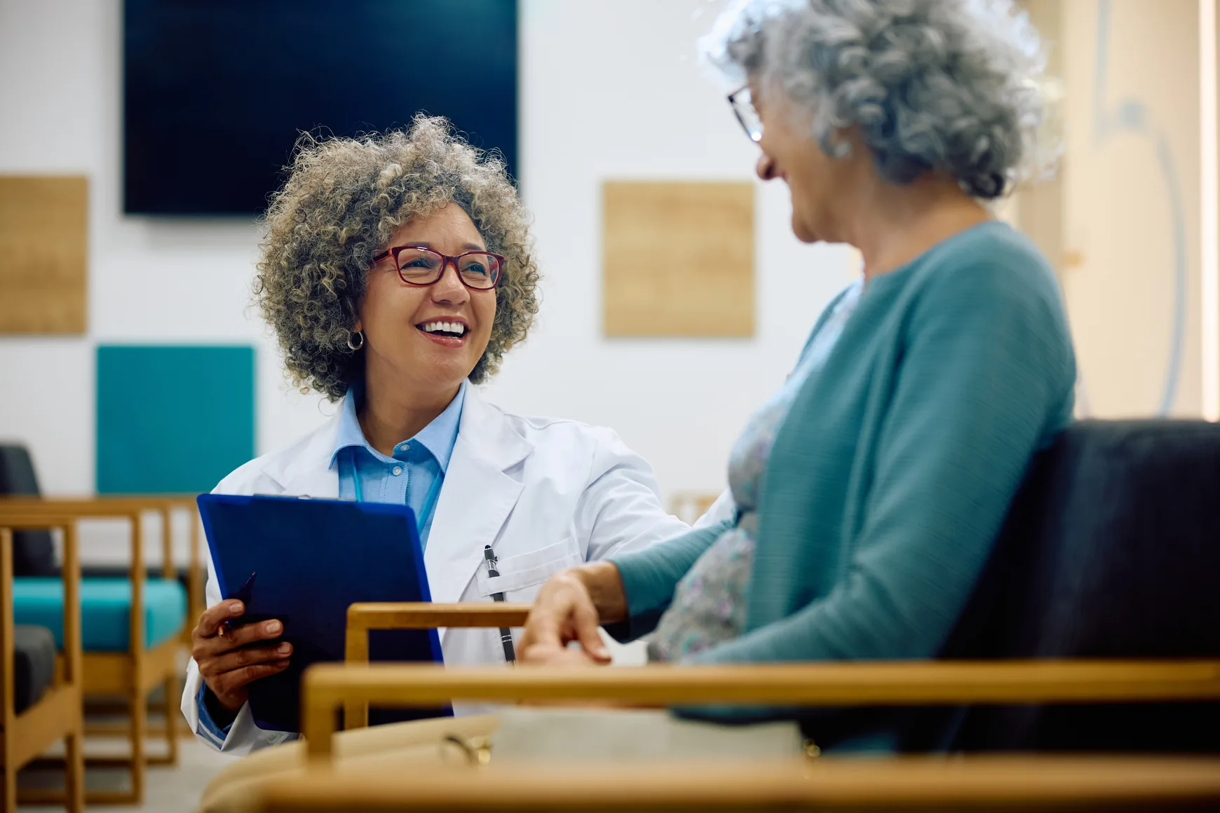 A physician talking with a patient at an infusion center
