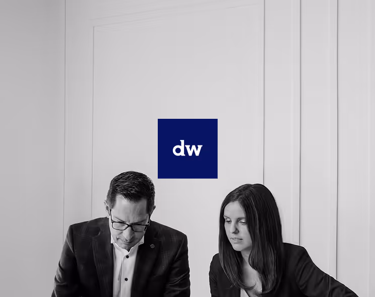 A black and white photo of two Diamond Willow partners, with the new blue and white logo in the center.