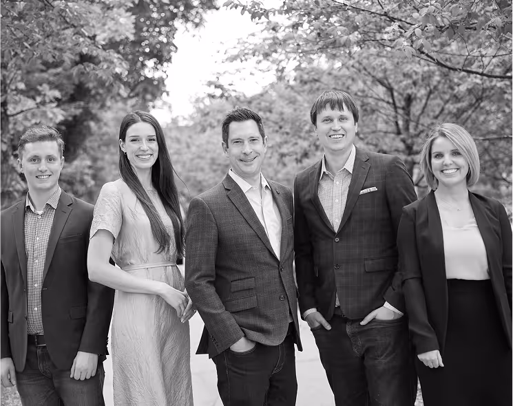 Black and white group photo of five Diamond Willow employees.