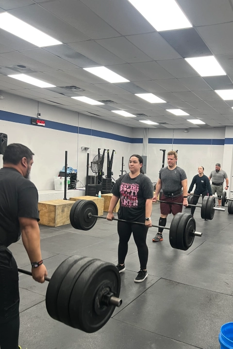 A group of people lifting barbells during Olympic Lifting Sessions at CrossFit Empire South in Huntsville, AL.