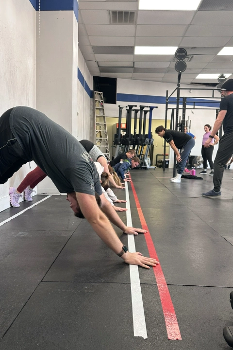 CrossFit training session at CrossFit Empire South in Huntsville, AL, showcasing diverse fitness activities and participants.