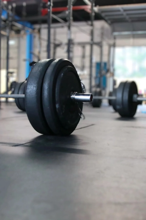 Close-up of a barbell resting on the floor at CrossFit Empire South gym in Huntsville, AL.