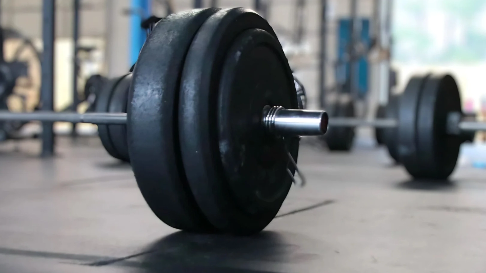 Close-up of a barbell resting on the floor at CrossFit Empire South gym in Huntsville, AL.