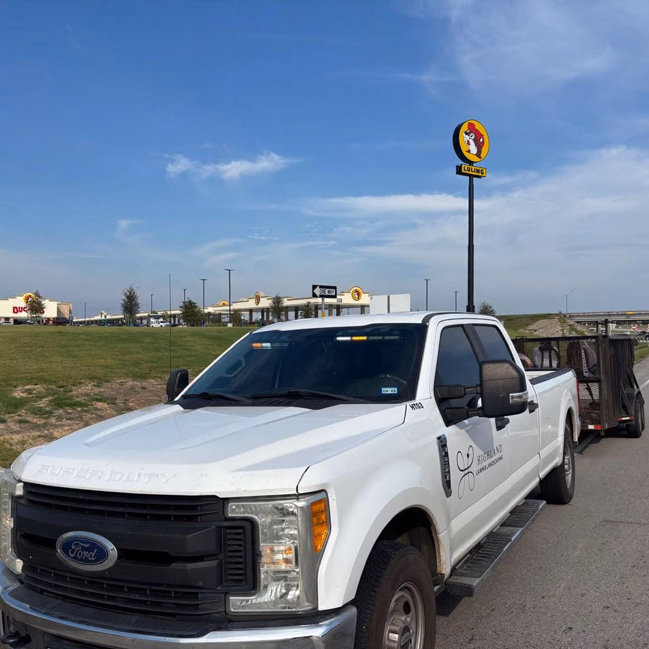 Highland Lawn & Landscaping truck on-site for landscape maintenance