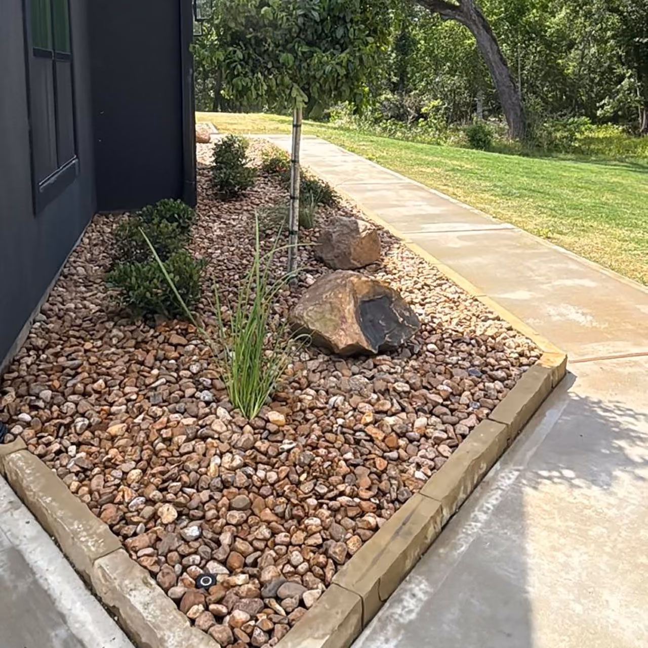 Highland Lawn & Landscaping crew completing a commercial landscape installation in Fort Bend County