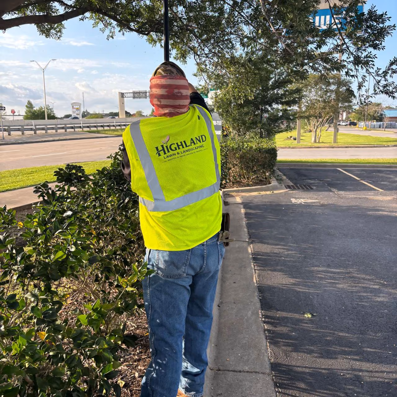 Landscaping apprentice working on professional landscape maintenance