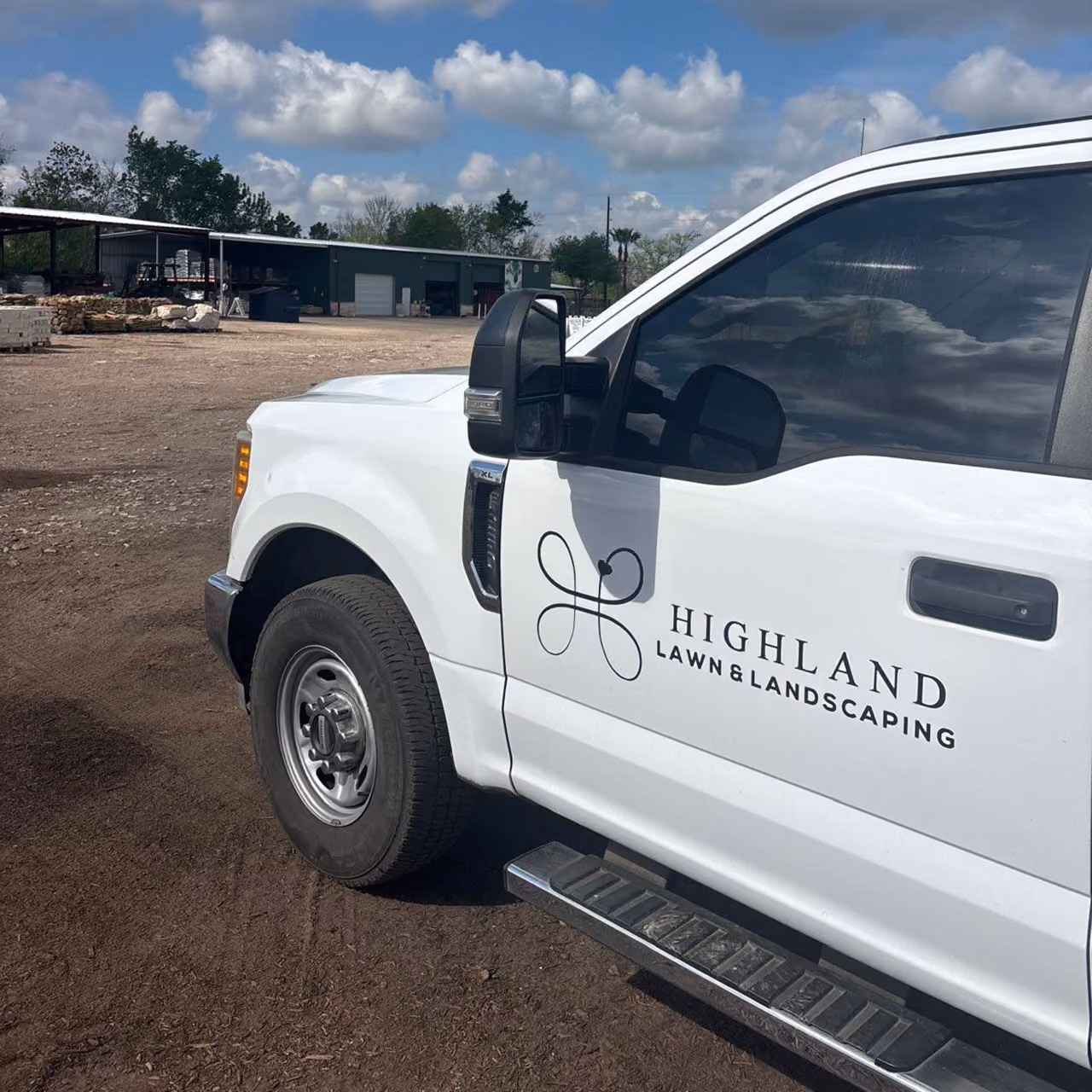Highland Lawn & Landscaping company truck at a commercial property in Brazoria County