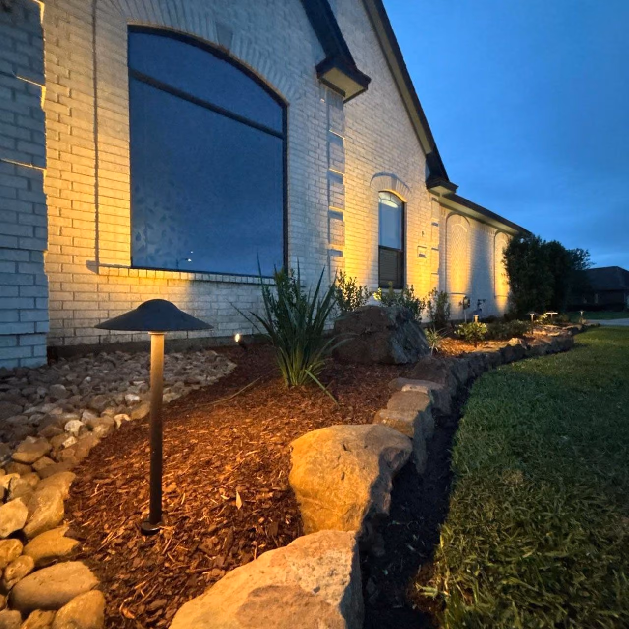 Professional landscape lighting installation by Highland Lawn & Landscaping in Brazoria County