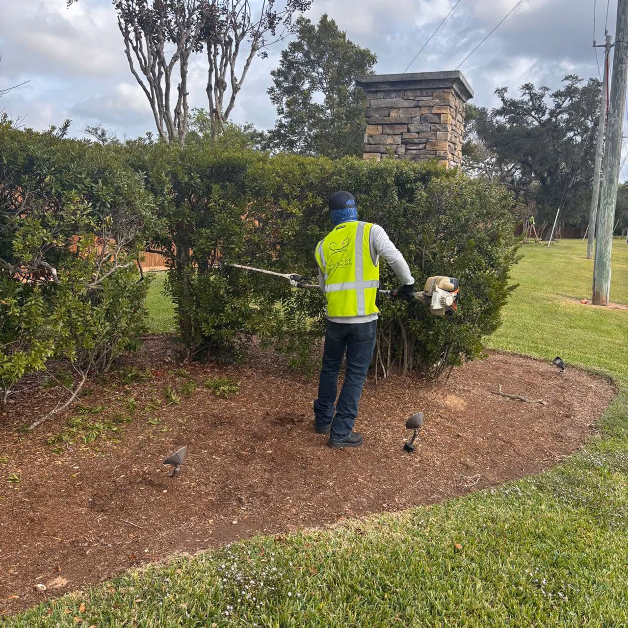 Professional landscaping worker maintaining commercial property near me
