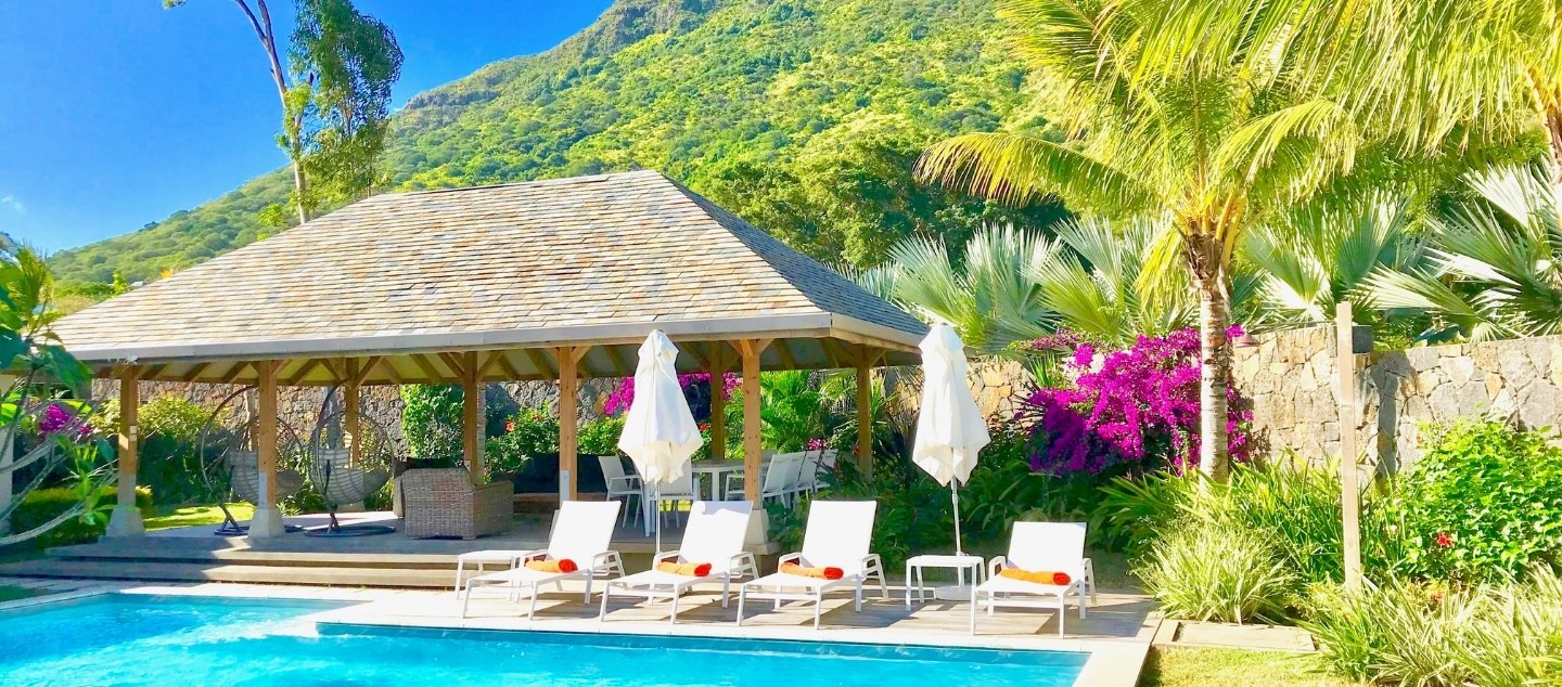 Turquoise pool and sun loungers at the Prestige Pool Villa with MJ Holidays in Mauritius.