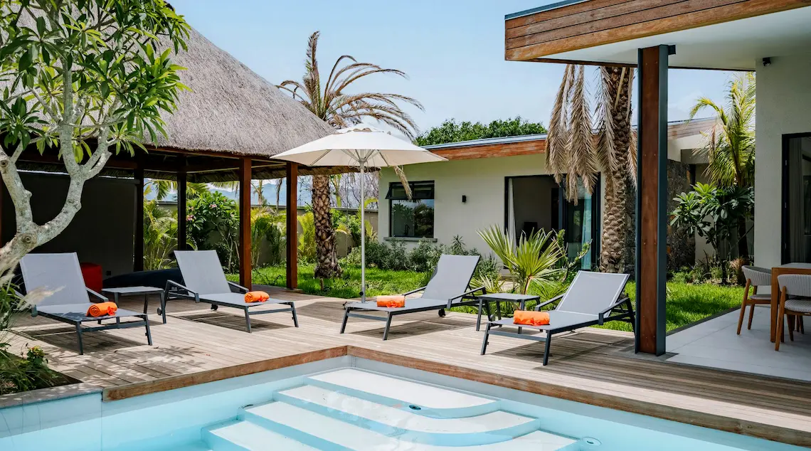 Pool surrounded by sun loungers and greenery at the Serenity Pool Villa with MJ Holidays in Mauritius.