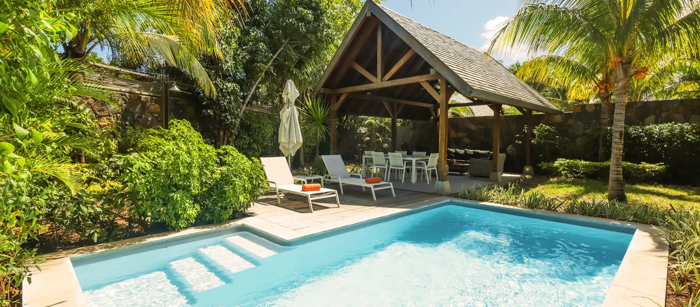 Peaceful pool and sun loungers at the Superior Pool Villa with MJ Holidays in Mauritius.