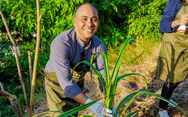 A person planting a tree in Mauritius, a symbol of ecological commitment and sustainable initiatives supported by MJ Holidays.