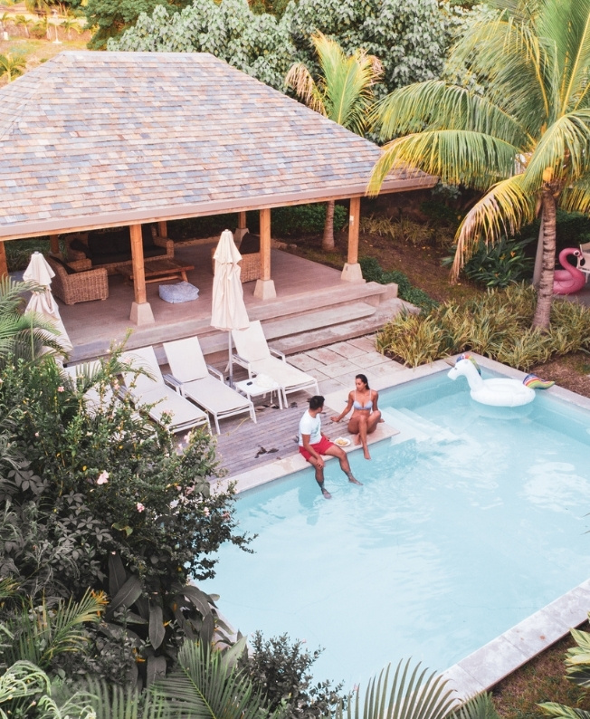 A couple enjoying a private pool in Mauritius, a symbol of relaxation and romance during a stay with MJ Holidays.