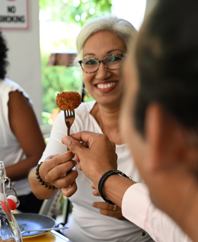 A convivial moment shared among friends in Mauritius, illustrating the joie de vivre and hospitality that characterise MJ Holidays holidays.