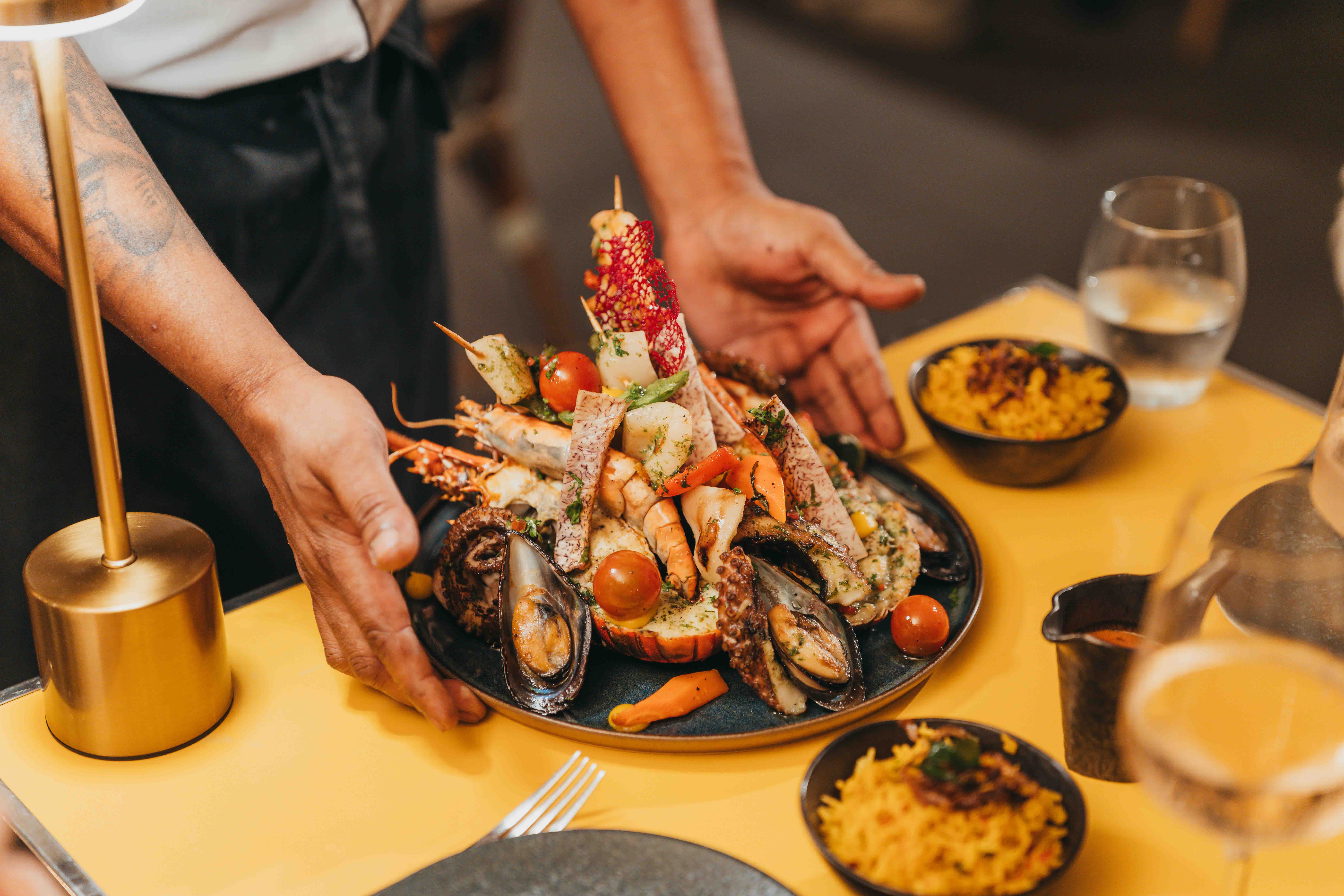 Top view of a dish and a drink at the Restaurant L'Atelier with MJ Holidays in Grand-Gaube.