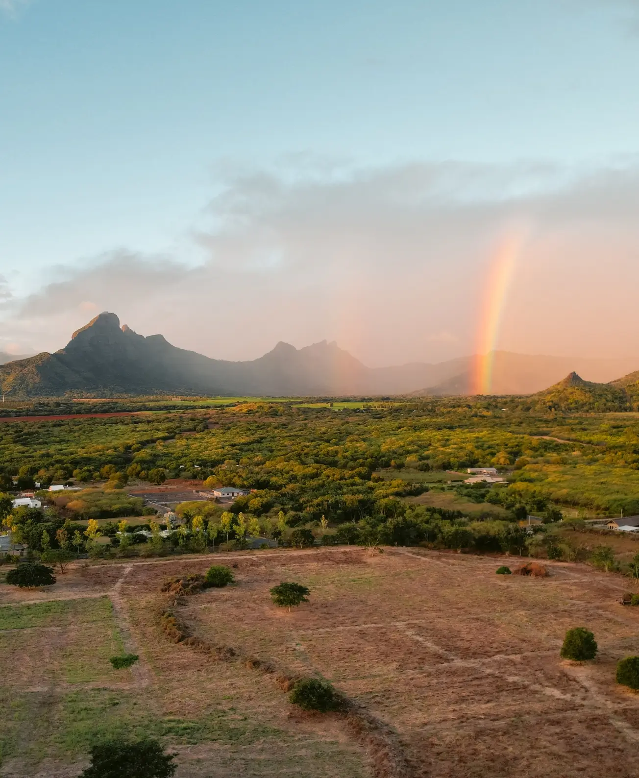 Vibrant rainbow over the tropical landscapes of Mauritius with MJ Holidays.