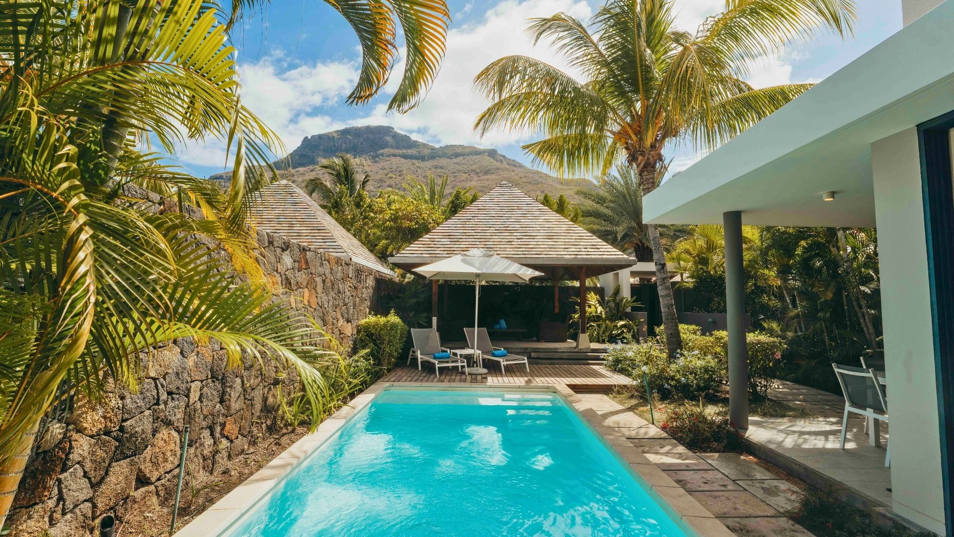 Piscine privée entourée de transats à la Superior Pool Villa avec MJ Holidays à l’île Maurice.