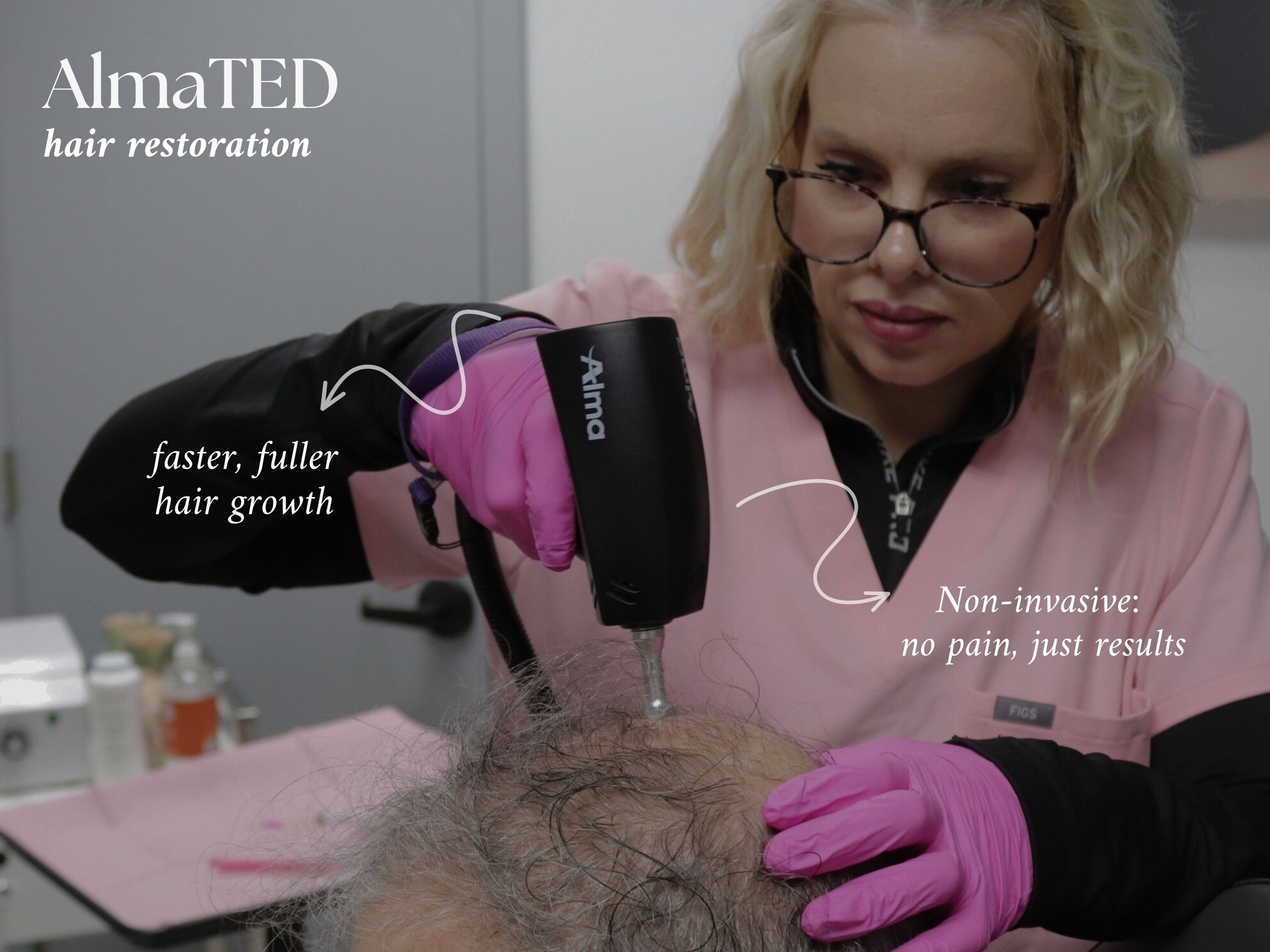 Woman in pink scrubs and gloves performing a non-invasive hair restoration treatment with a handheld device on a patient's scalp.