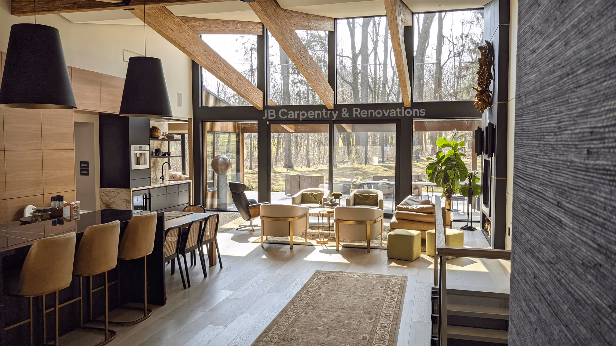 Open-concept living and kitchen space featuring exposed wood beams, floor-to-ceiling windows, and custom millwork — a modern renovation by JB Carpentry & Renovations.