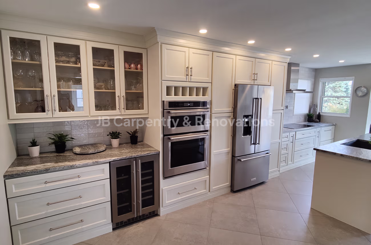 Full luxury kitchen renovation with built-in appliances, quartz countertops, and under-cabinet lighting — JB Carpentry & Renovations.