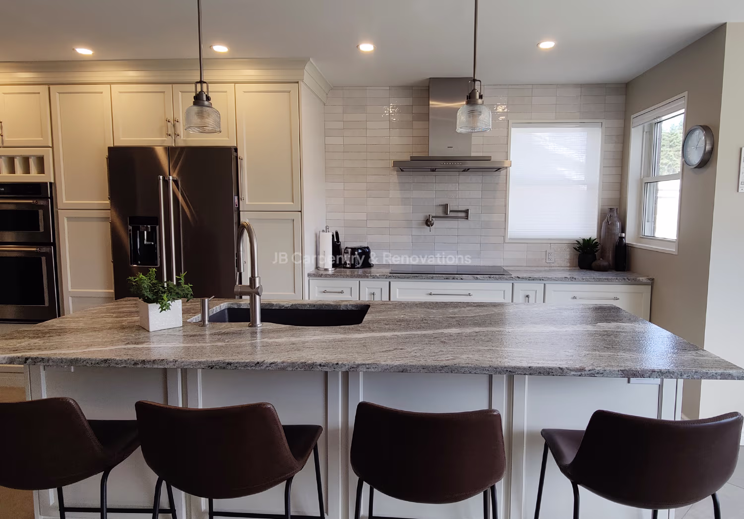 ChatGPT said: Alt text: Modern kitchen interior with a large gray granite island countertop and four brown leather barstools. The space features white cabinetry, stainless steel appliances including a double oven and French-door refrigerator, and a sleek