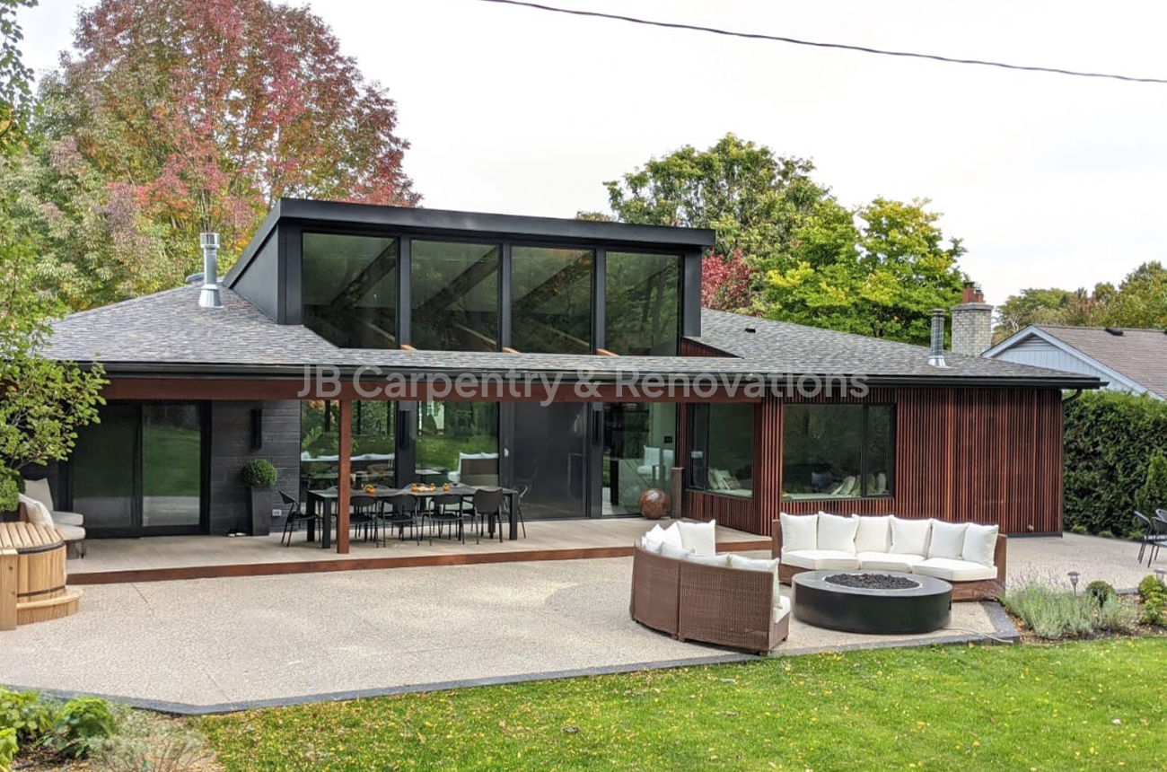 Contemporary new build with outdoor living area and patio – Sleek architectural design with expansive windows, wood detailing, and a large patio for entertaining.