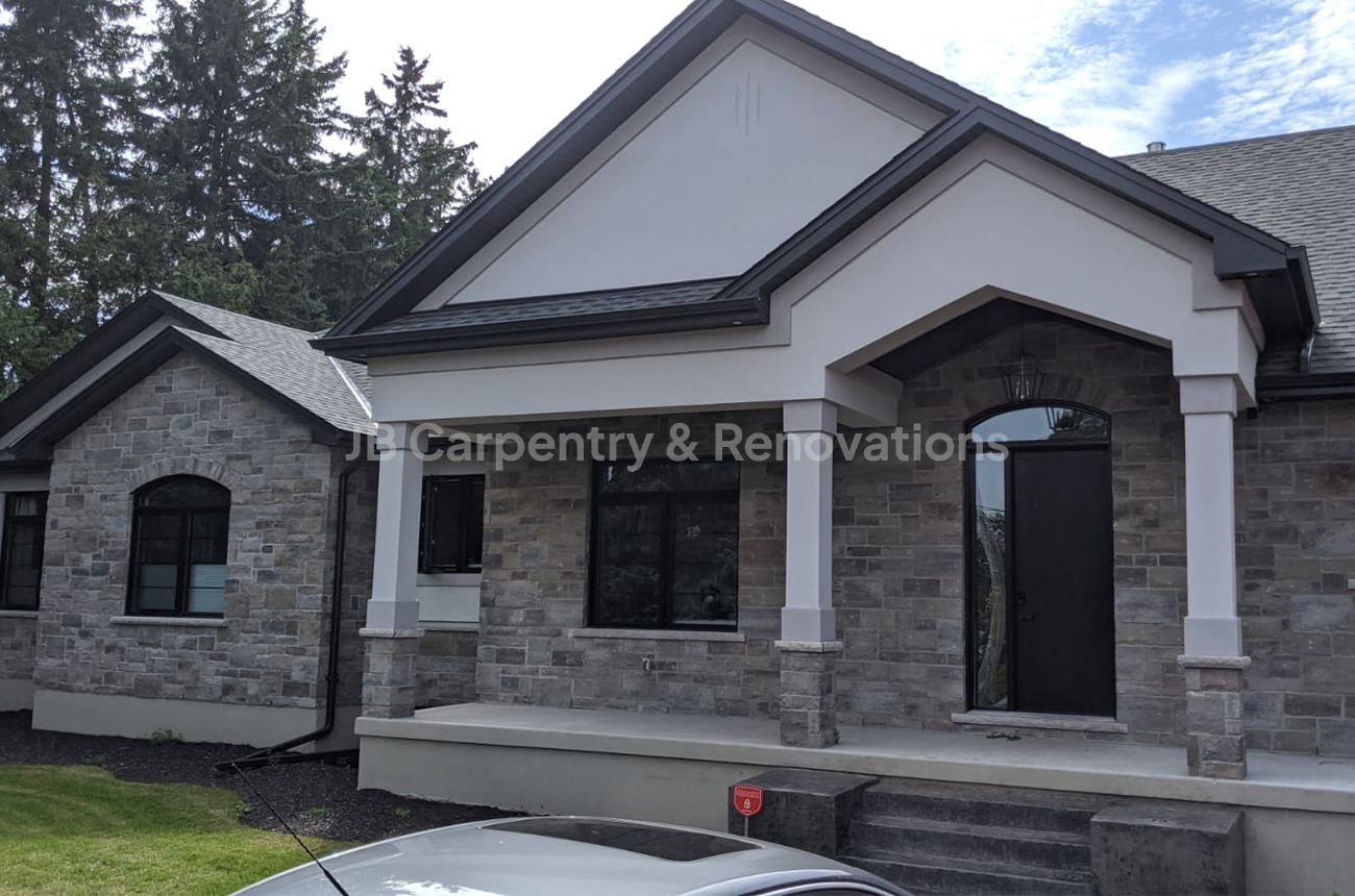Contemporary stone bungalow new build with black and white accents – Freshly built home showcasing a stone exterior, bold black window frames, and clean architectural lines.