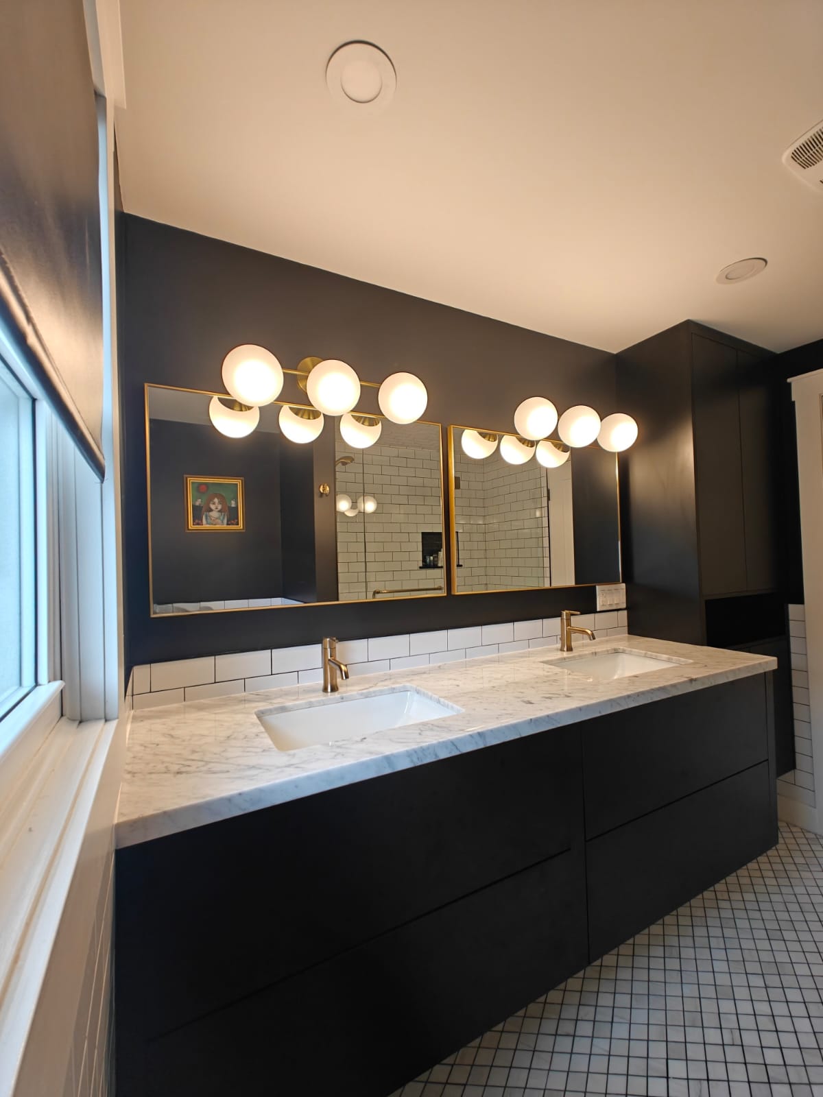 Dark vanity bathroom with globe lighting and double sinks – Sophisticated bathroom design with statement lighting, custom cabinetry, and elegant tile flooring.