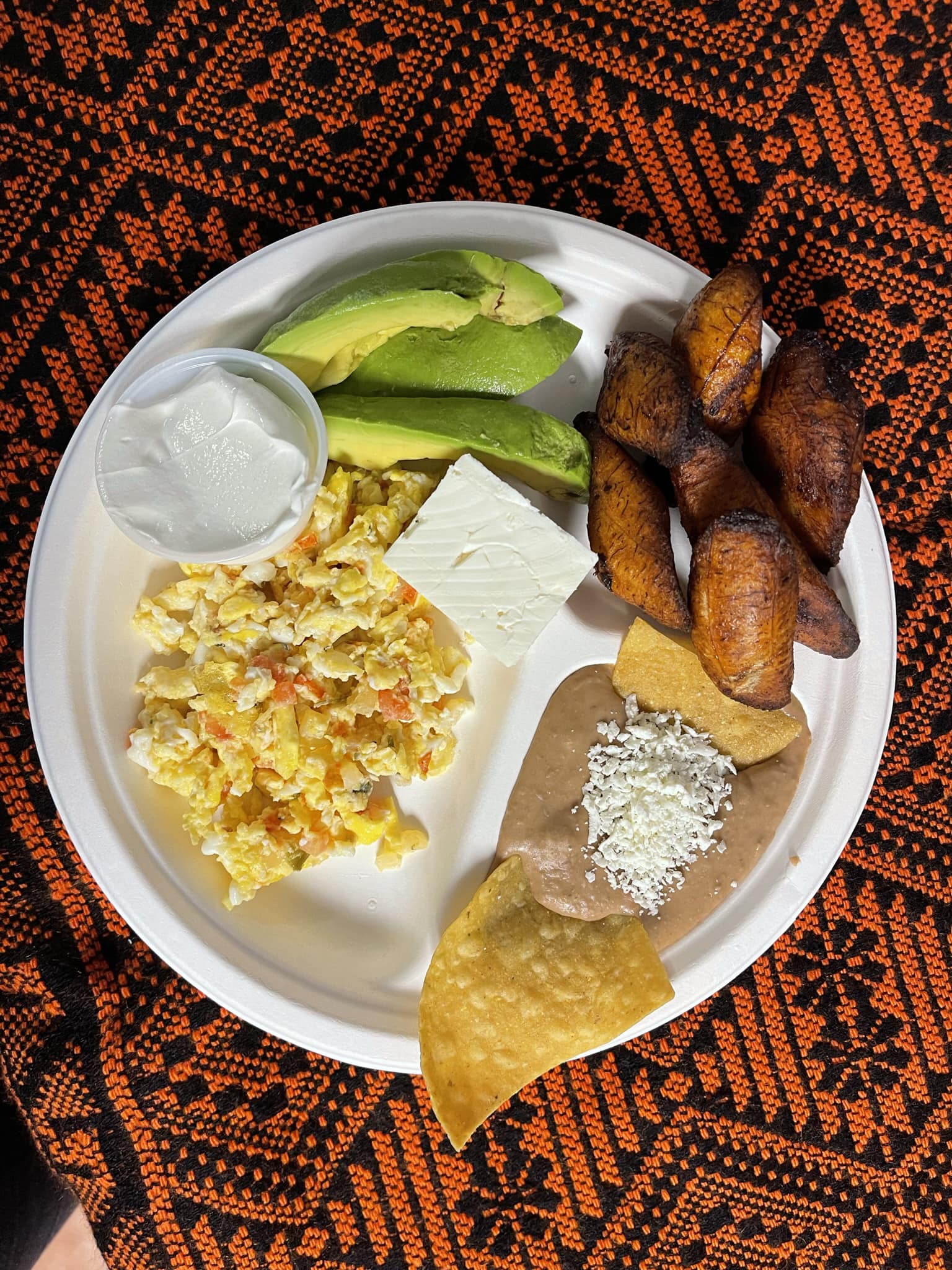 A beautifully presented plate of food sits on a table, featuring an assortment of vibrant ingredients and textures.